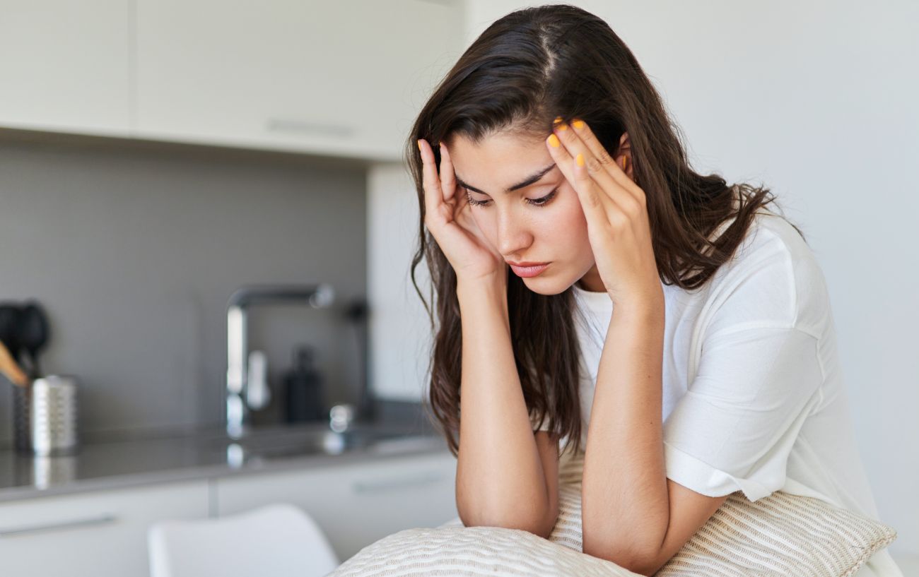 woman with anxiety putting her hands on her head