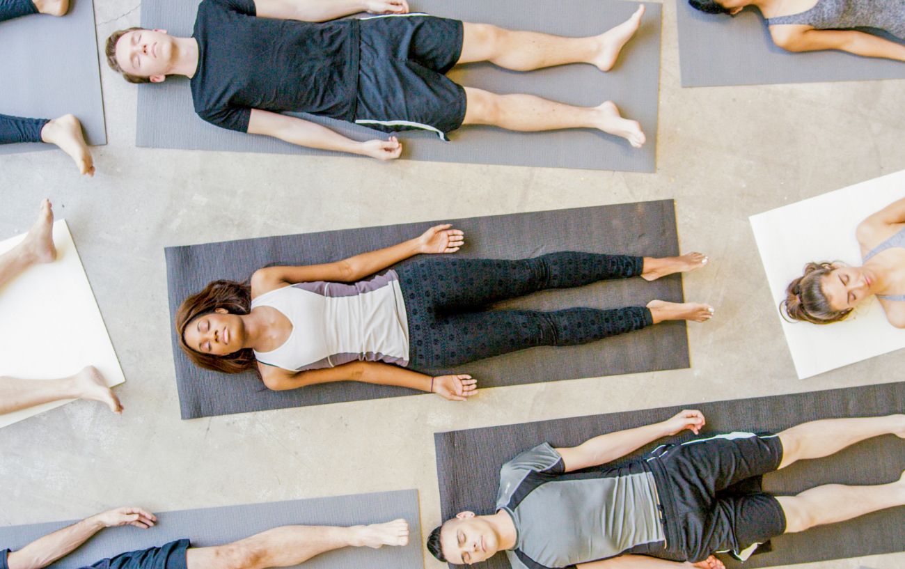 group yoga class in savasana