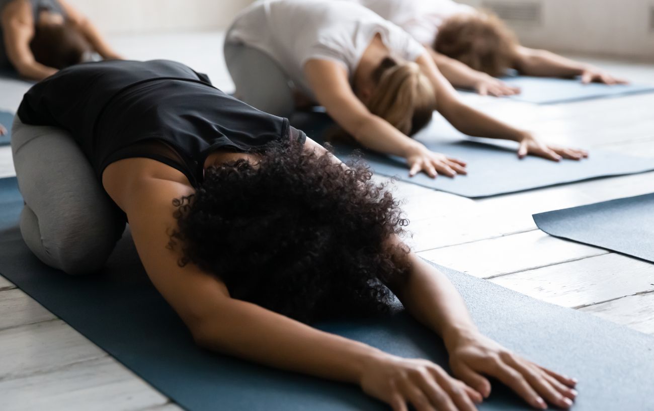 class of yoga students in balasana