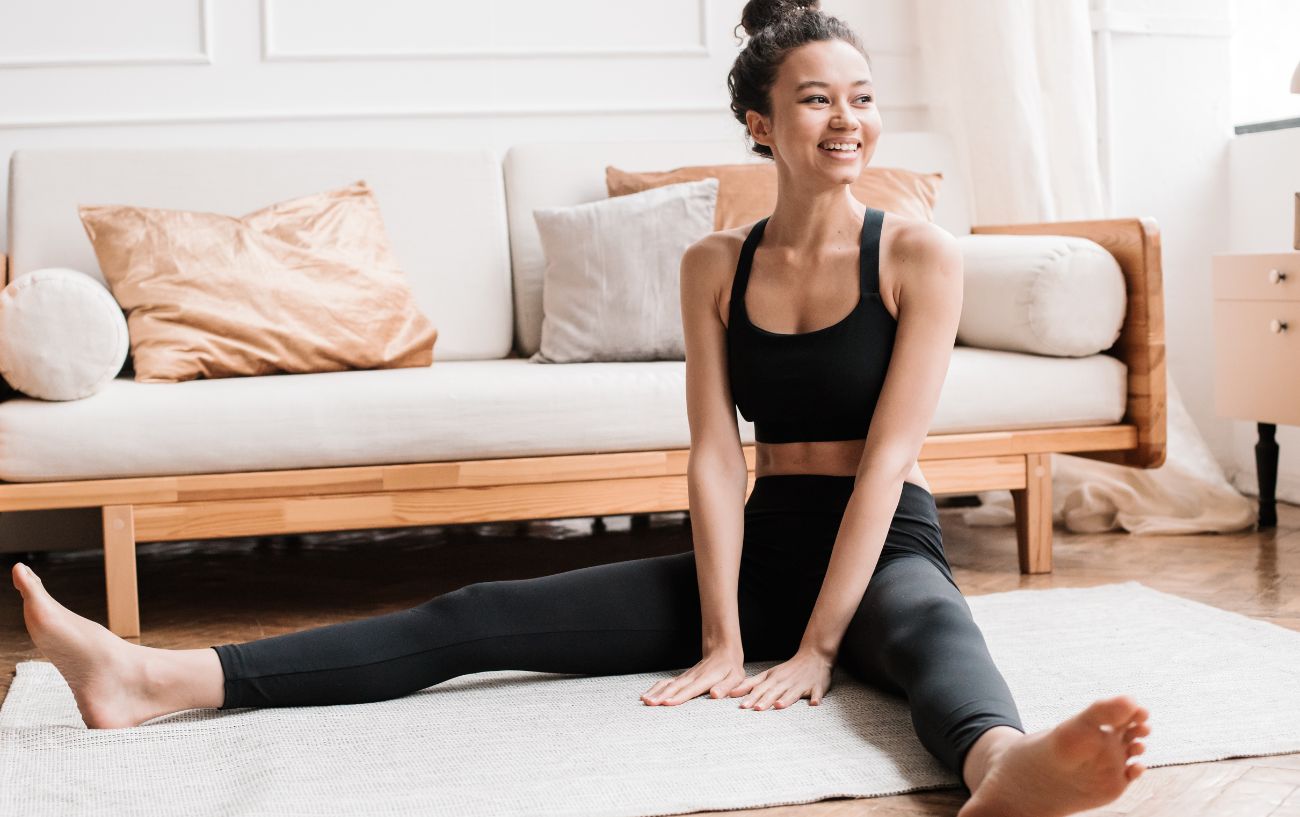 a woman doing seated yoga poses on a mat