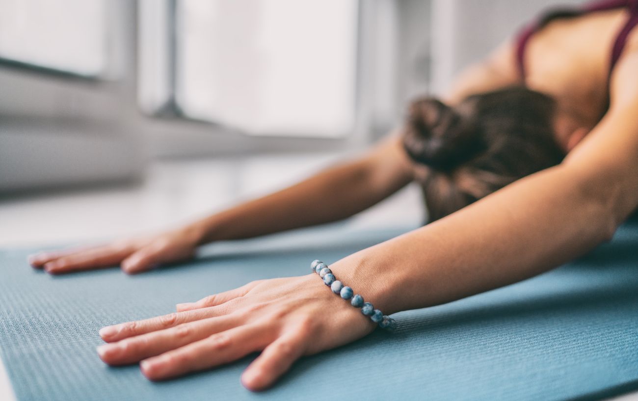 a woman's hands as she's in child's pose