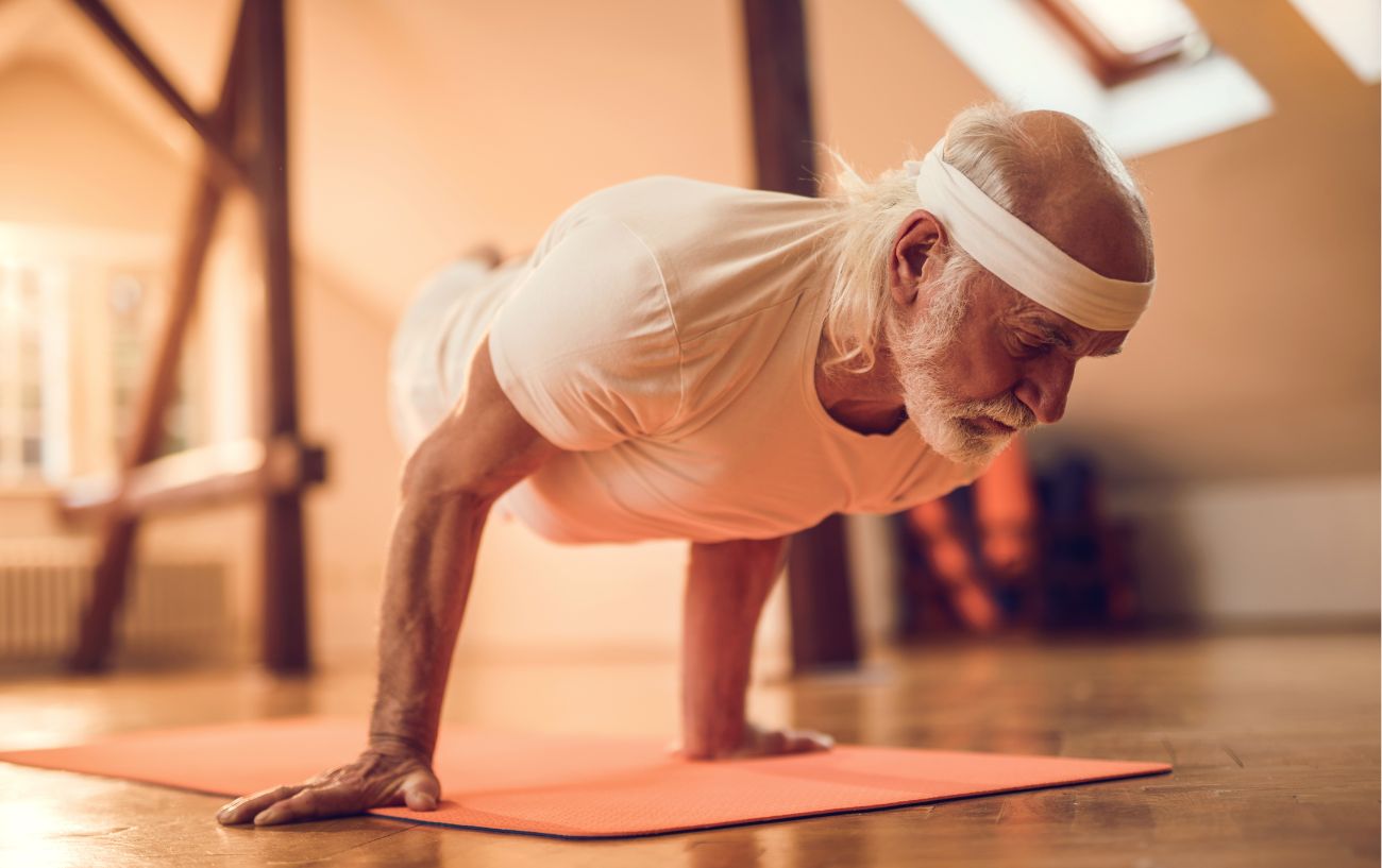 a man doing peacock pose with a bandana on 