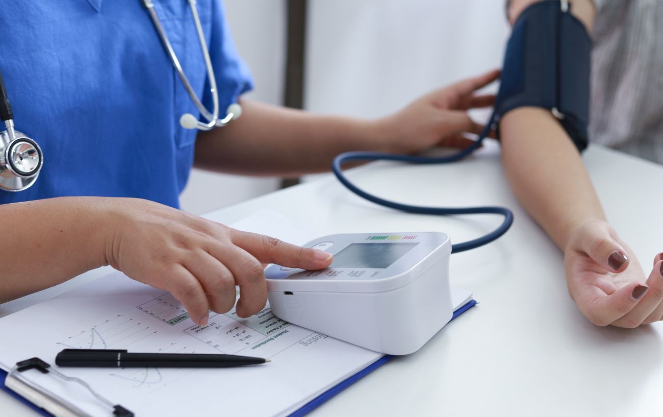 someones blood pressure being taken by a nurse