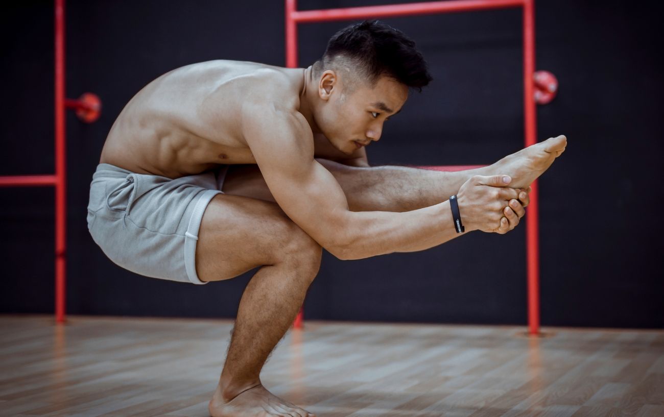 man doing yoga poses on one leg