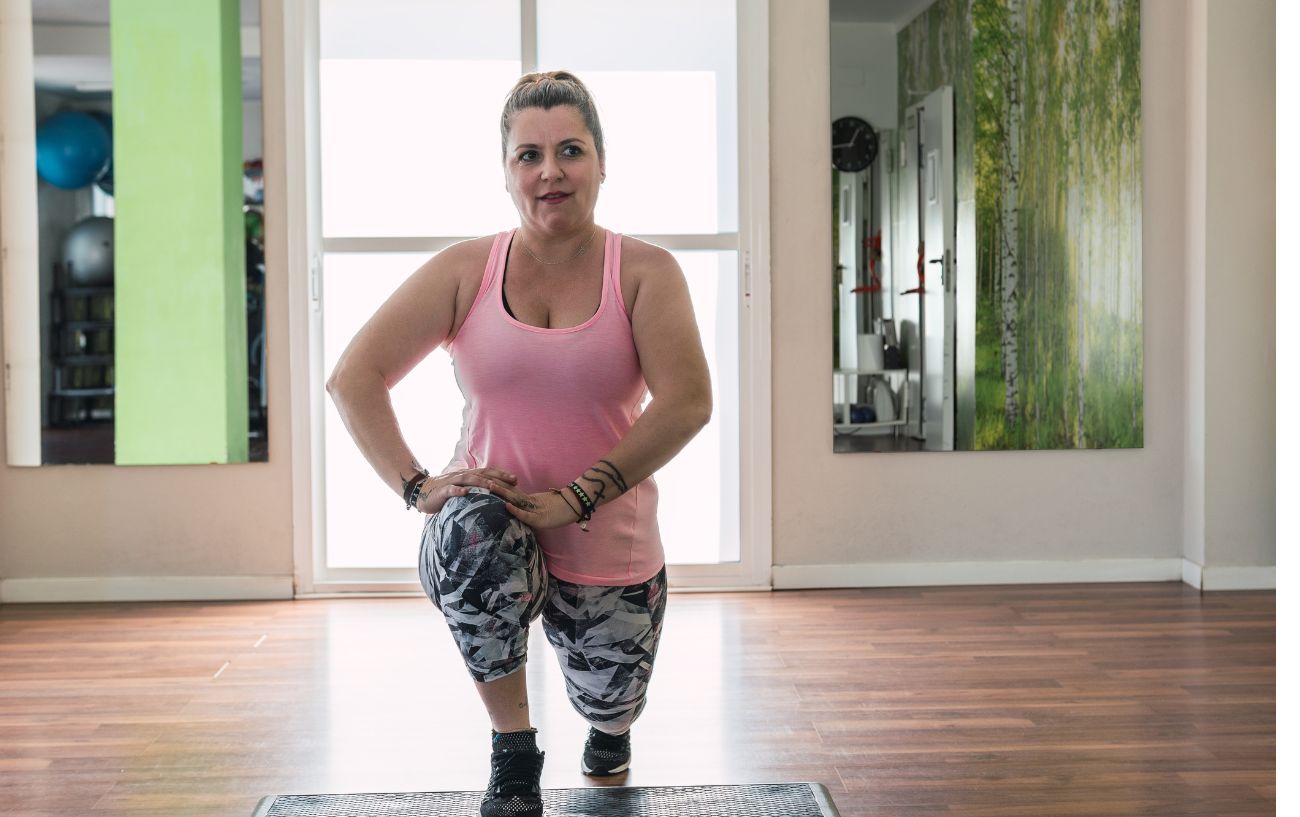 woman doing a low lunge off a step