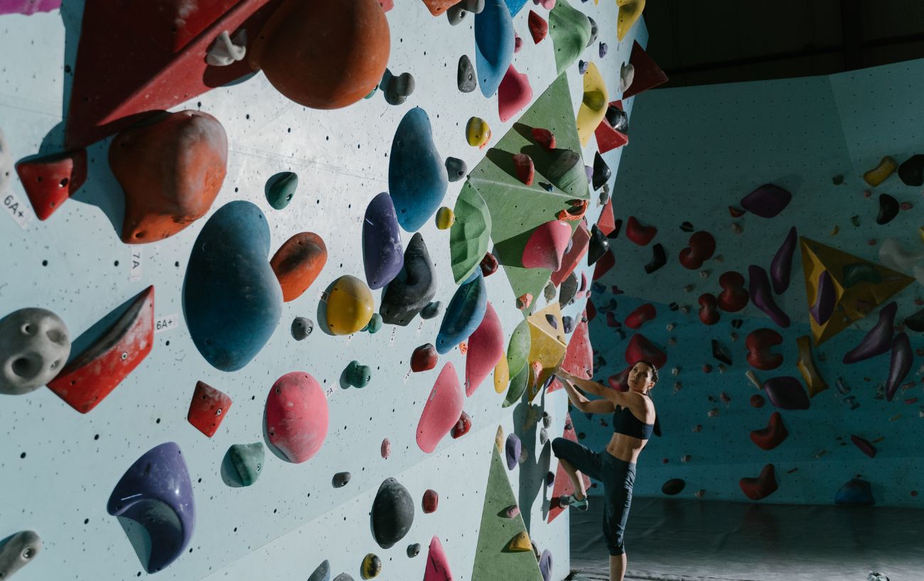 woman climbing at indoor climbing wall