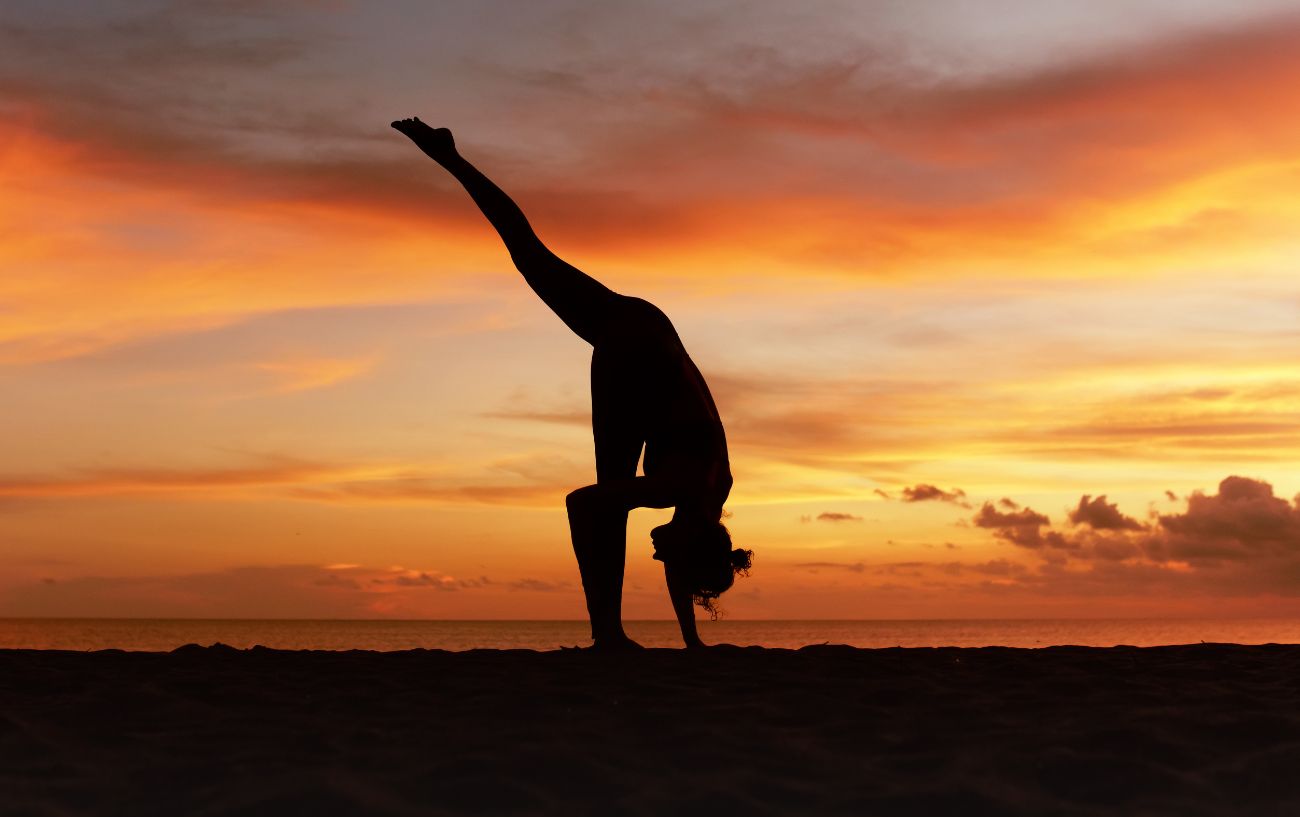 person in standing splits yoga pose on one leg 