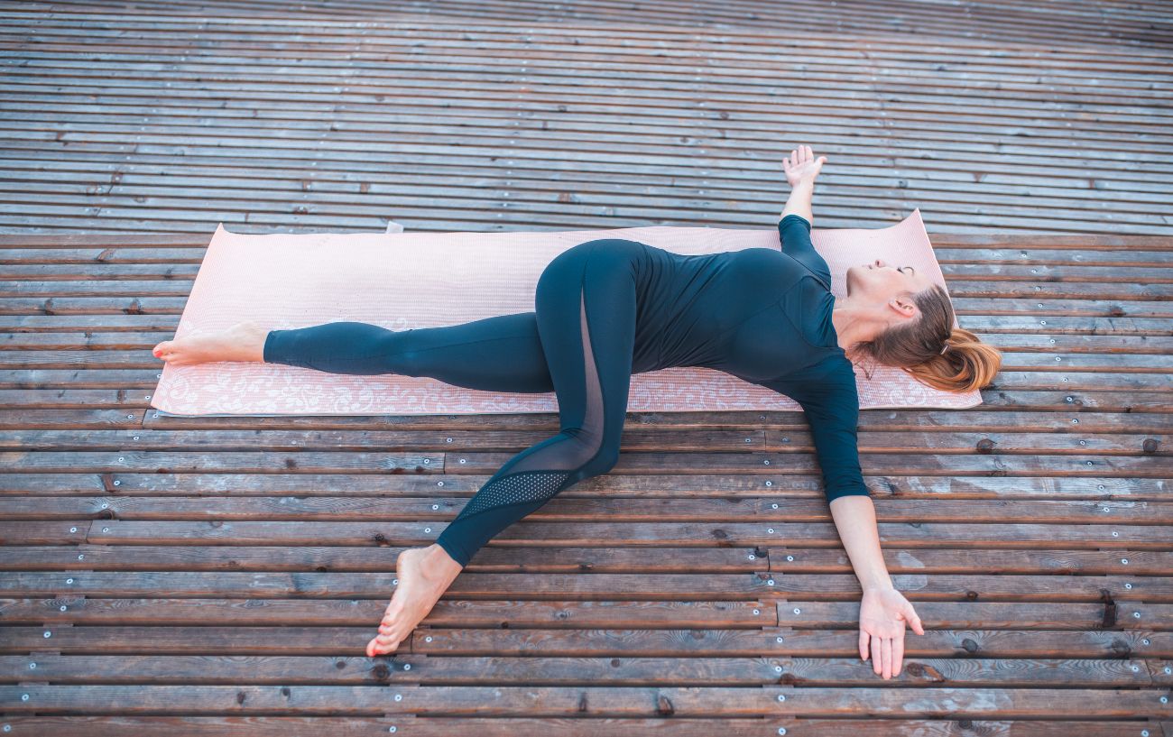 yogi practicing yoga for bowel movement pose - reclined twist 