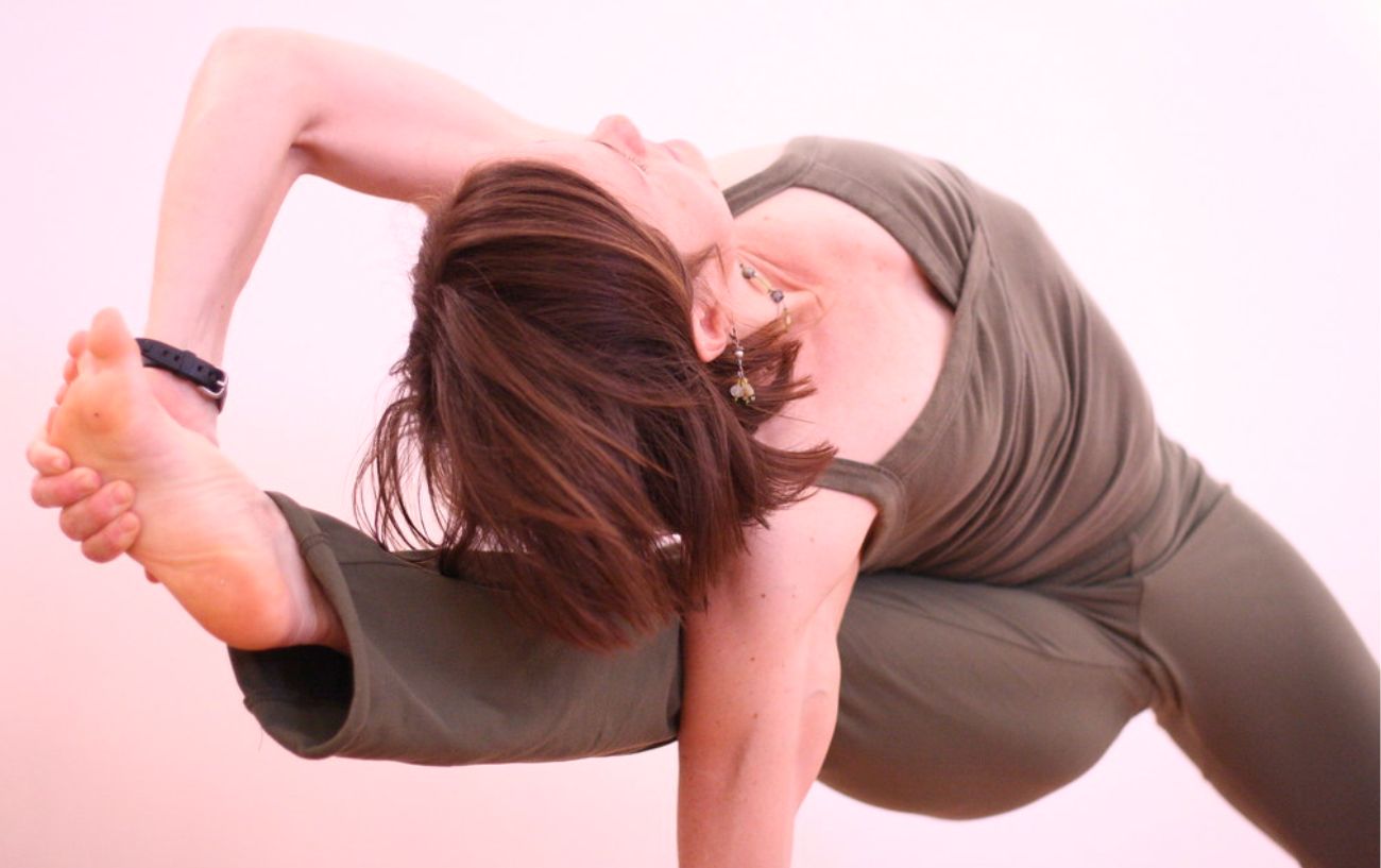 woman doing Sage Visvamitra’s Pose