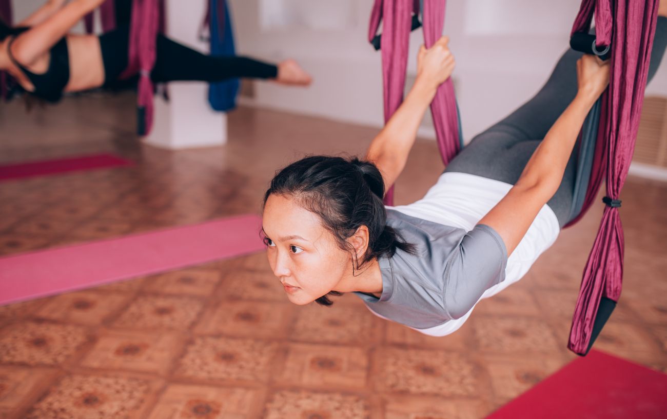 7 Aerial Yoga Benefits: From Spine Decompression To Improved Balance