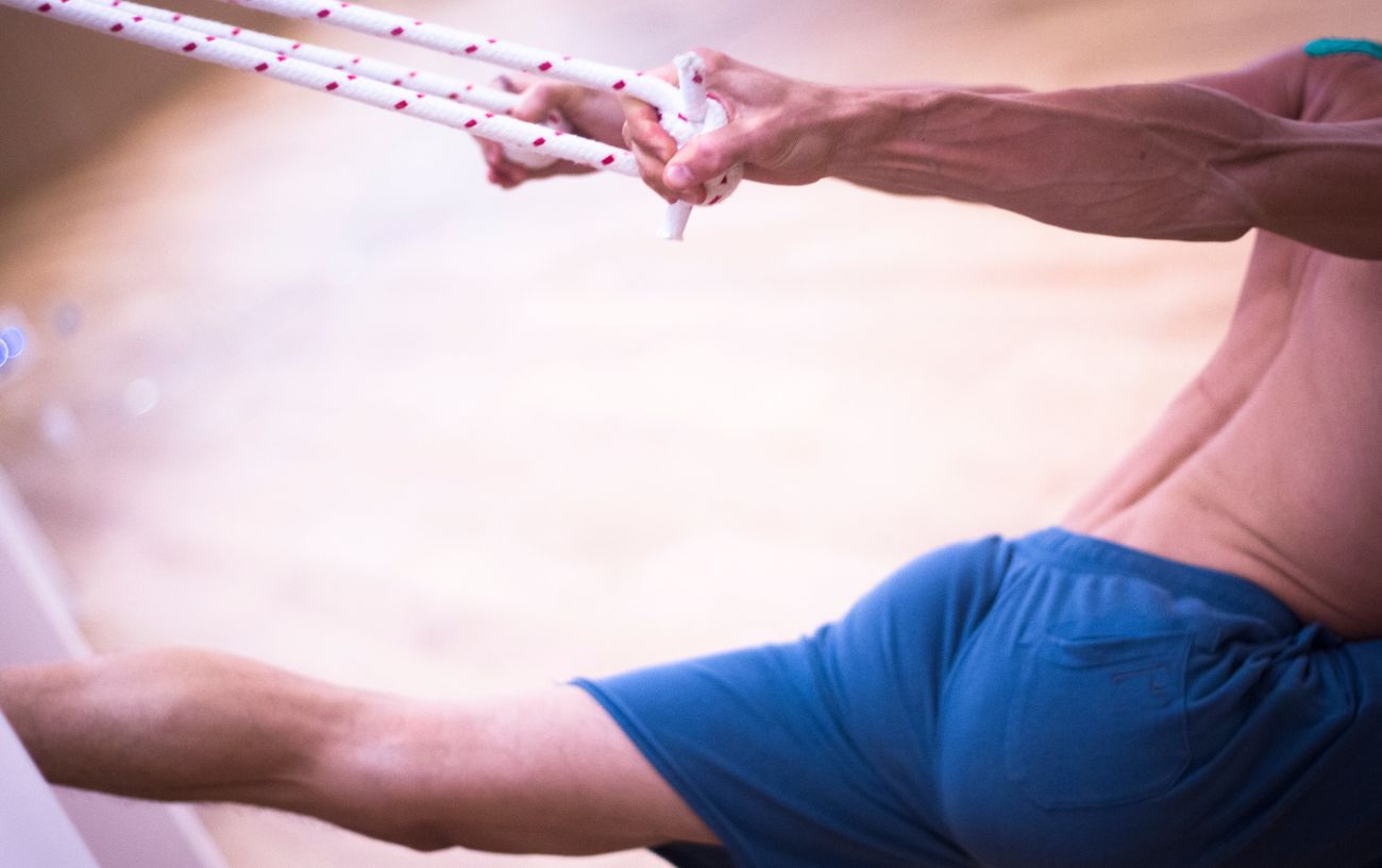 man using a yoga wall for balance