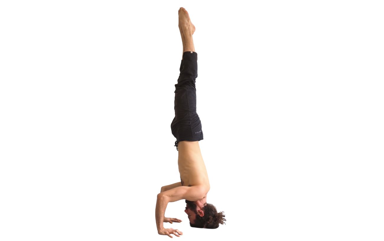 a man in tripod headstand