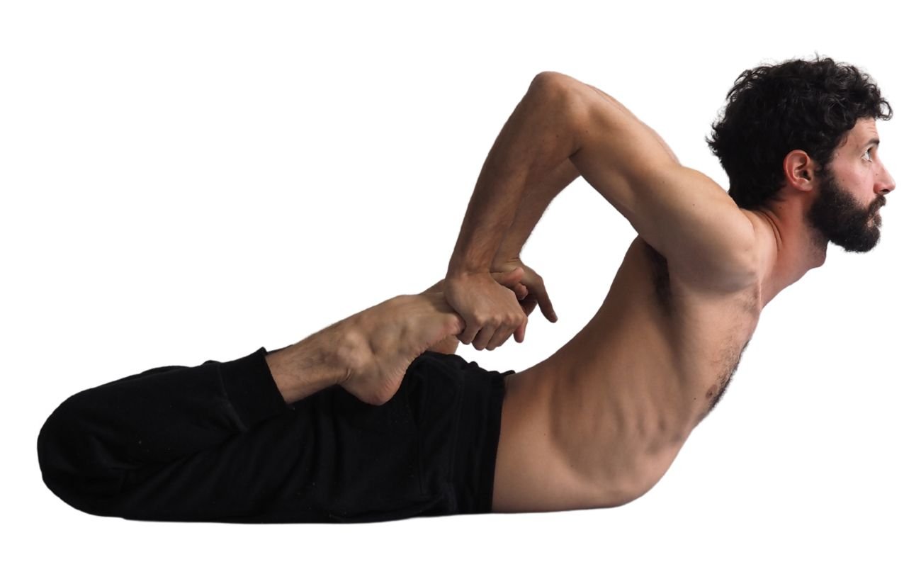 a man wearing black yoga clothes doing frog pose