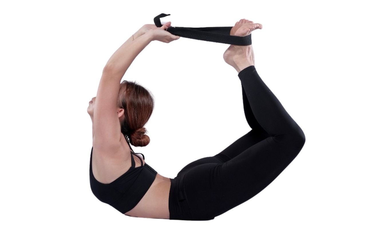 an image of a woman in black yoga clothes doing bow pose with a strap