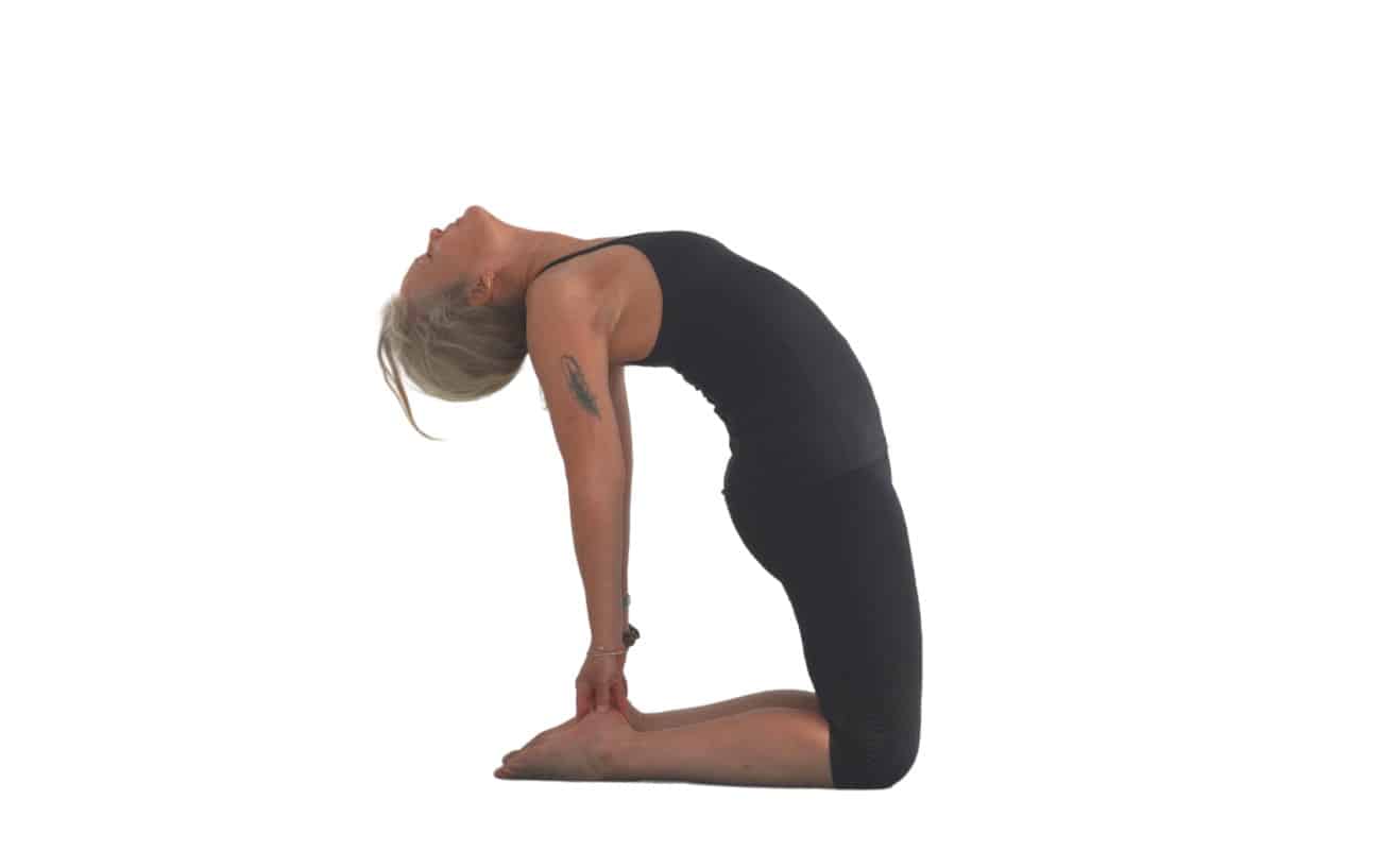 woman doing a camel pose