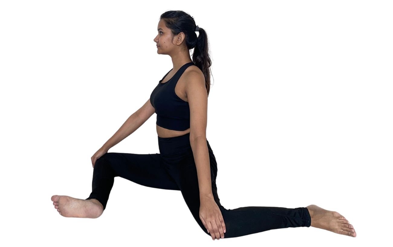 image of a woman in black yoga clothes doing deer pose