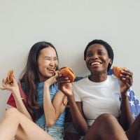 two women eating and laughing together