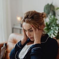 a woman feeling stress with her head in her hands