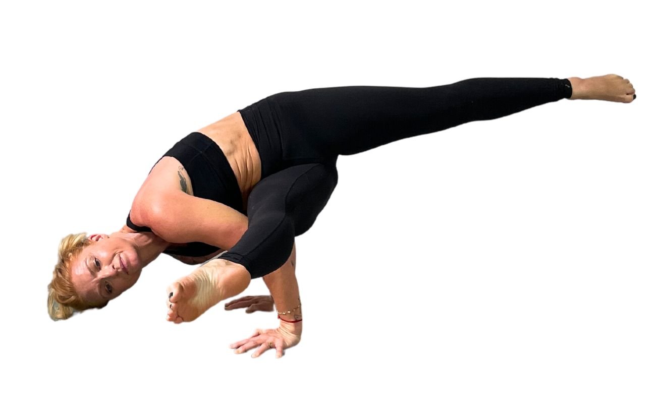 a woman wearing black yoga clothes doing Eka Pada Koundinyasana 1