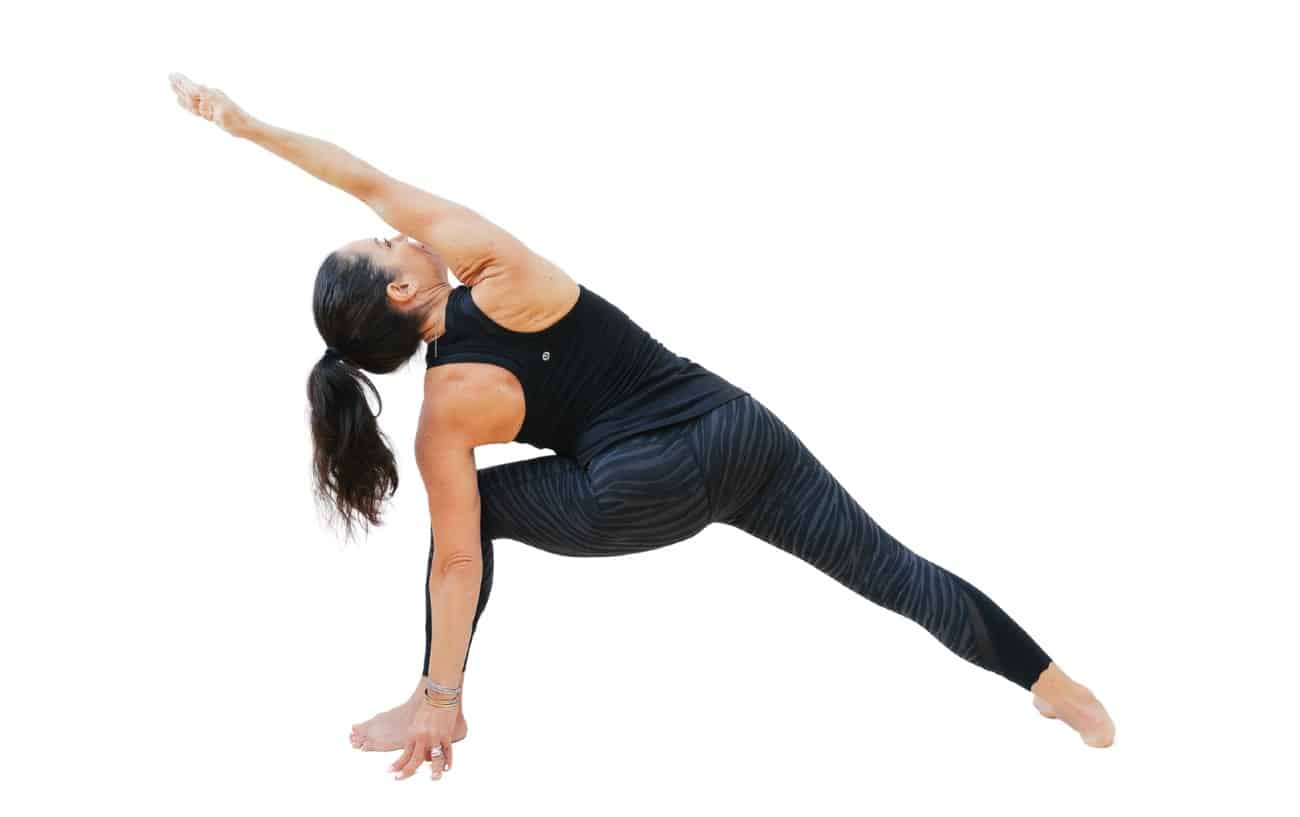 woman doing an extended side angle hand outside of foot yoga pose facing backwards