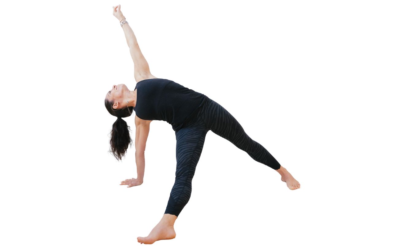 a woman wearing black yoga clothes doing fallen triangle pose