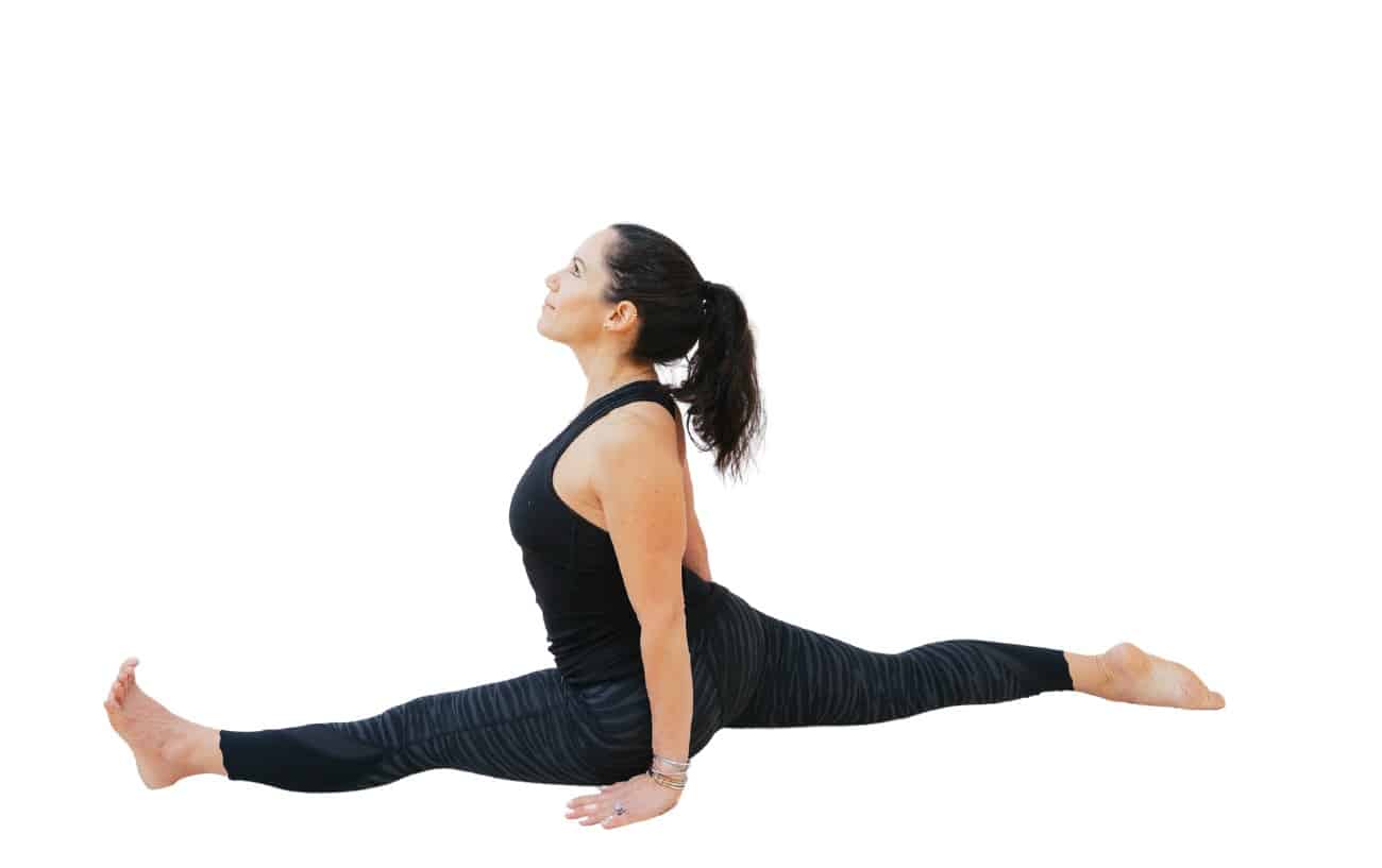 woman doing front split yoga pose with arms down