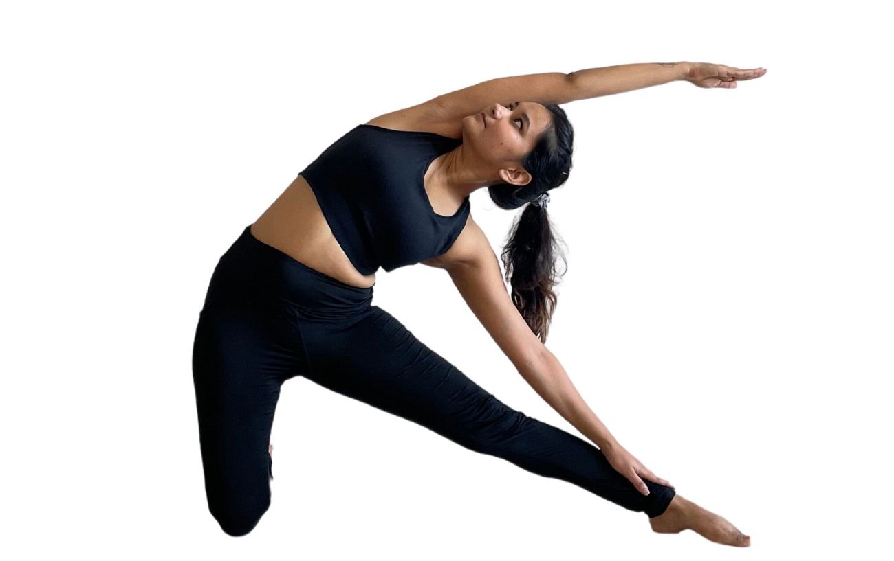 a woman wearing black yoga clothes doing gate pose 