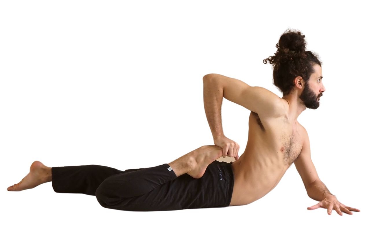 a man wearing black yoga trousers doing half frog pose