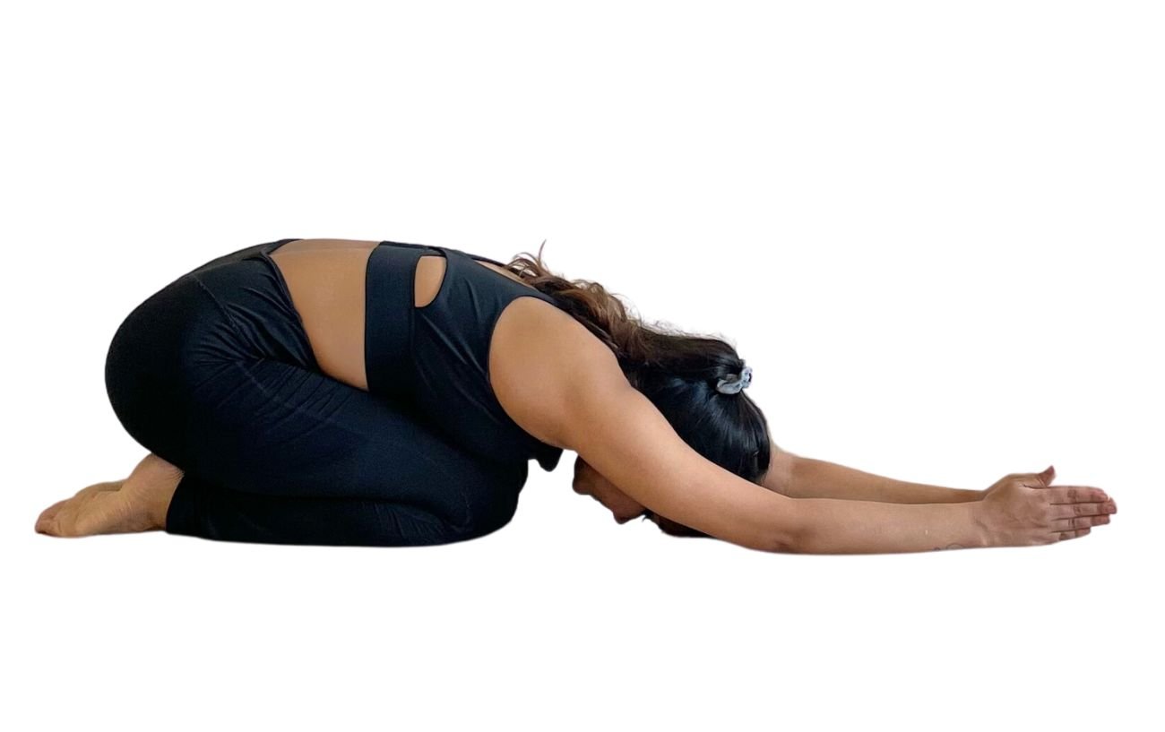 a woman wearing black yoga clothes doing half tortoise pose