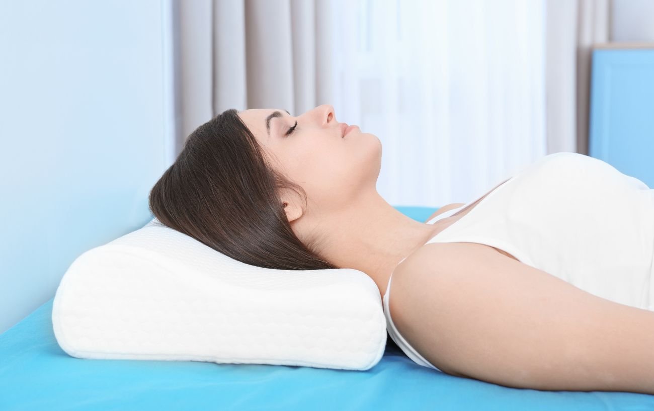 A woman lying on a special neck pillow.