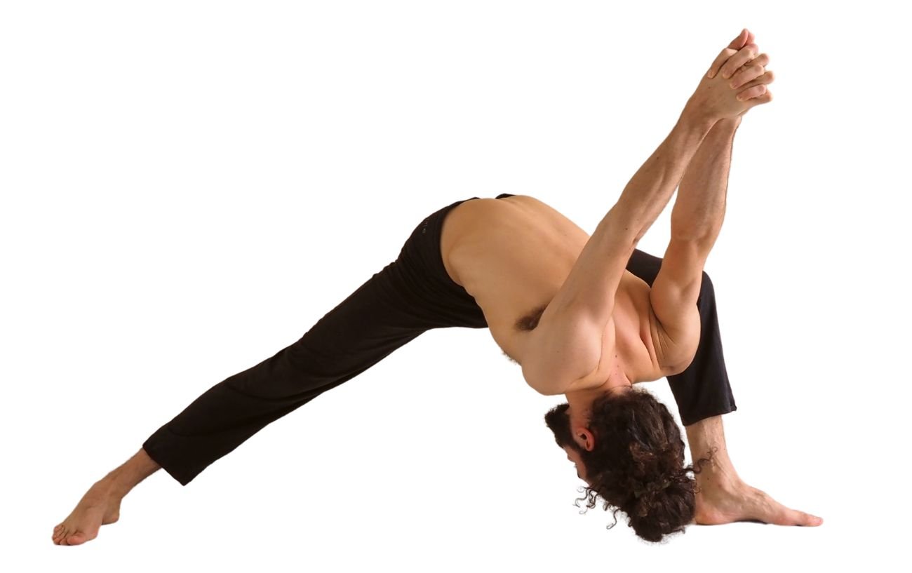 a man wearing black yoga trousers doing humble warrior pose