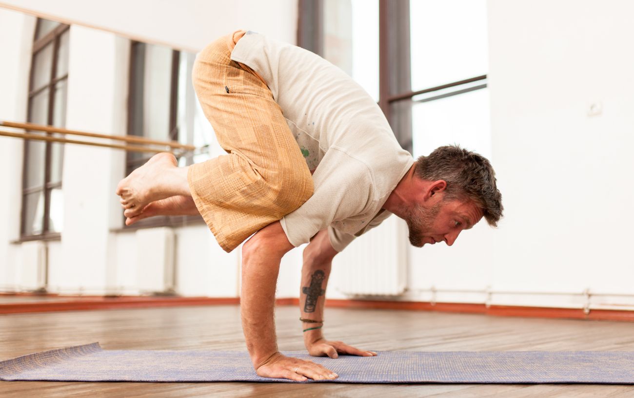 A man doing crow pose.