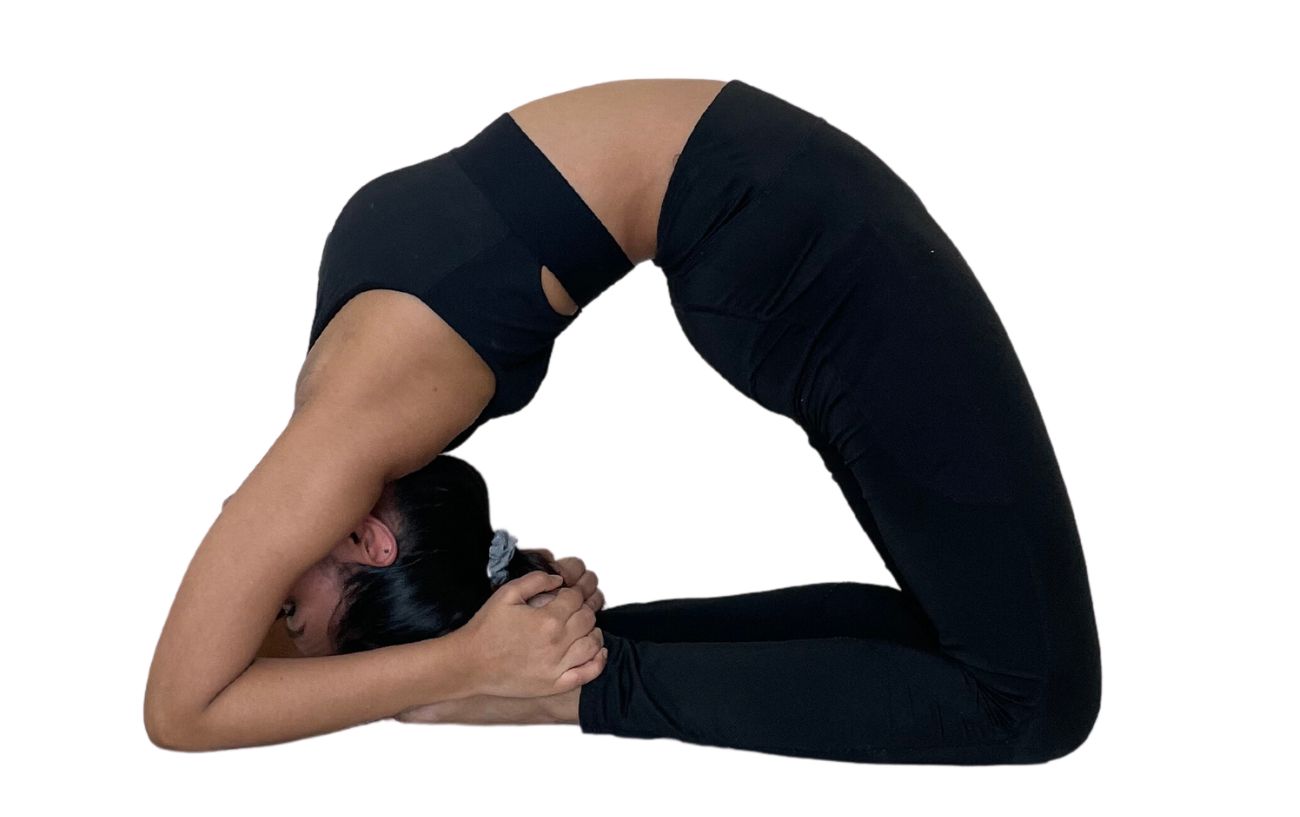 a woman wearing black yoga clothes doing kapotasana