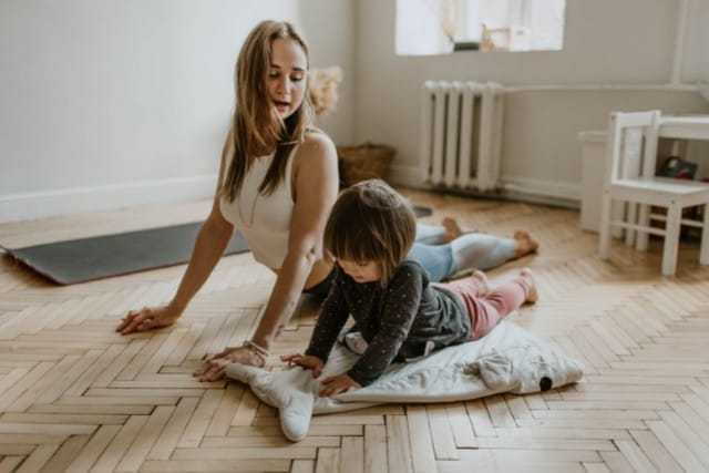 a mum and baby doing yoga