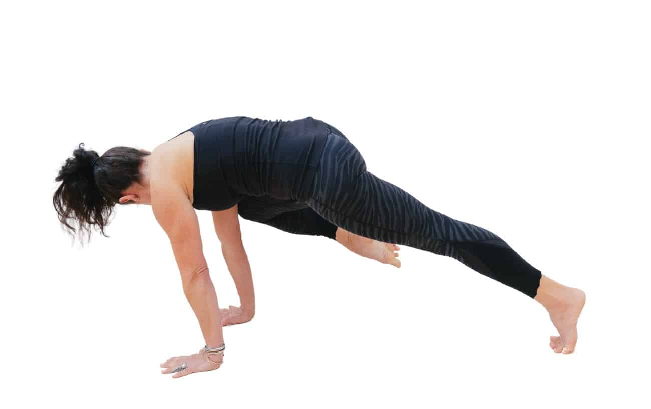 a woman doing knee to elbow plank pose with her back turned