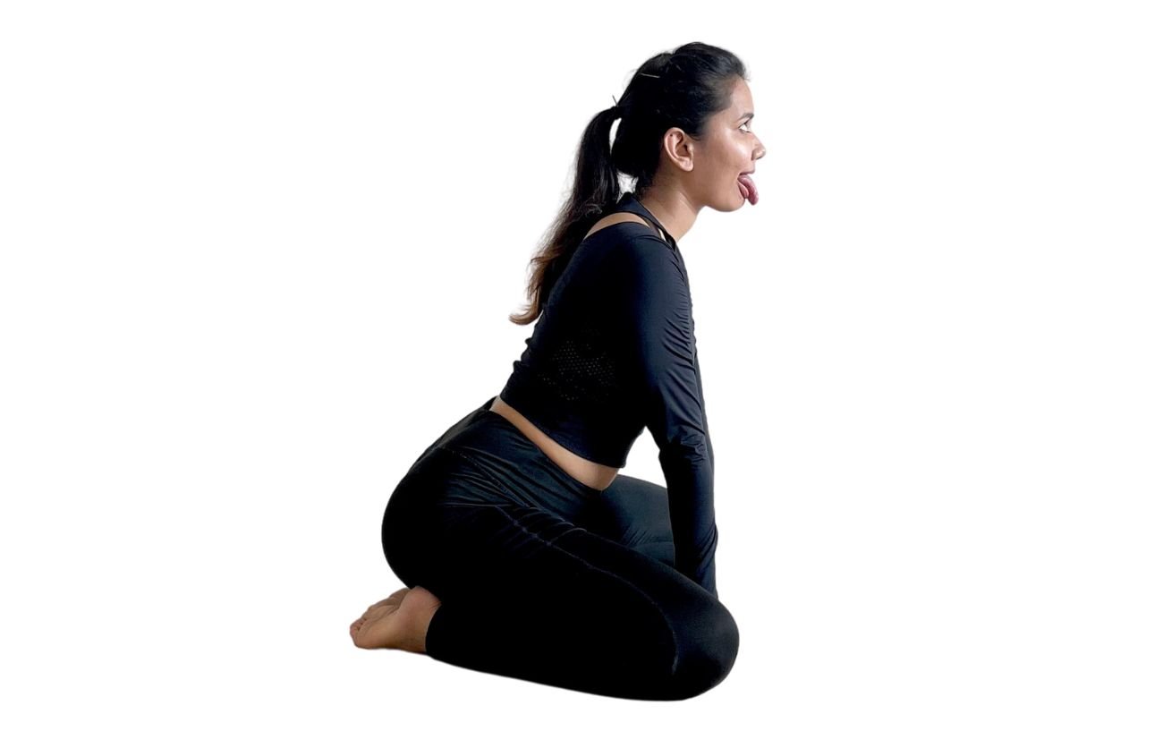 a side on photo of a woman wearing black yoga clothes doing lion pose