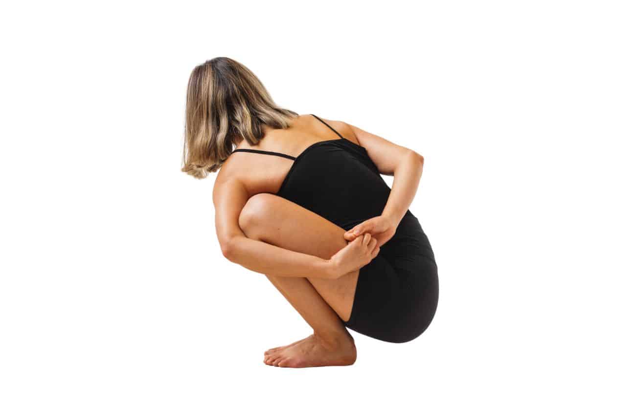 woman wearing black yoga clothes in noose pose