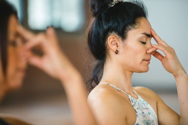 two women doing breathwork