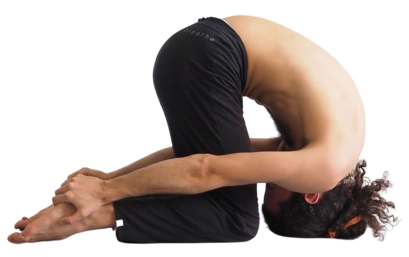 a photo of a man in black yoga pants doing rabbit pose