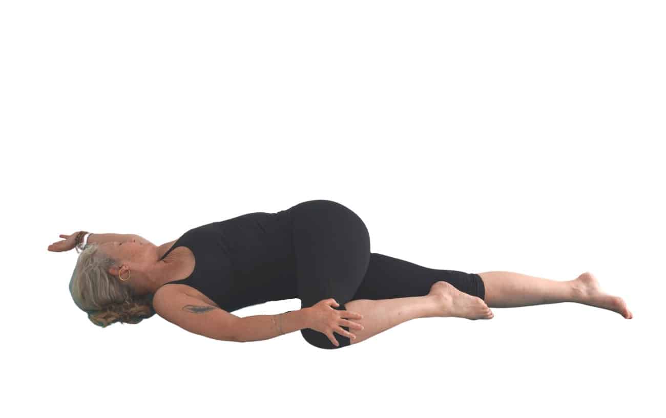 woman doing a supine spinal twist pose