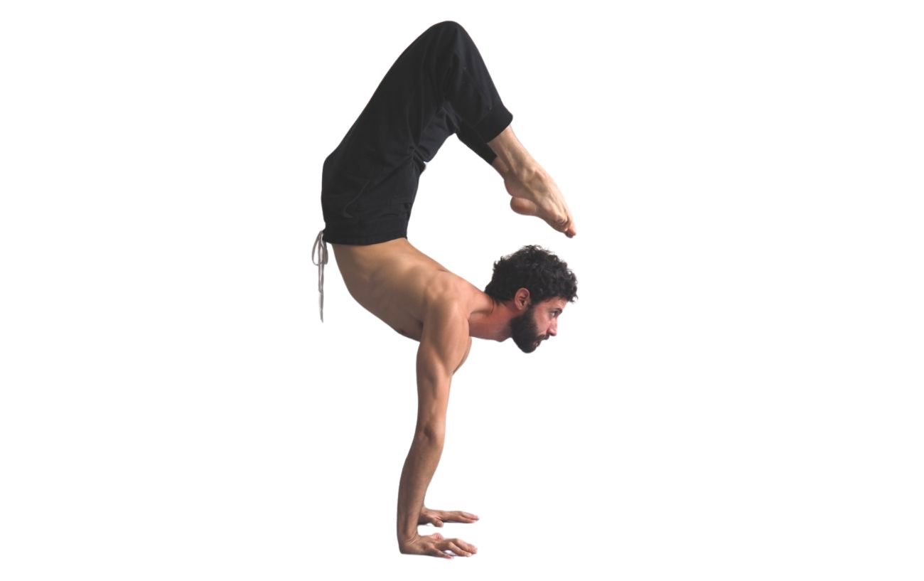 a man in black yoga trousers doing scorpion pose