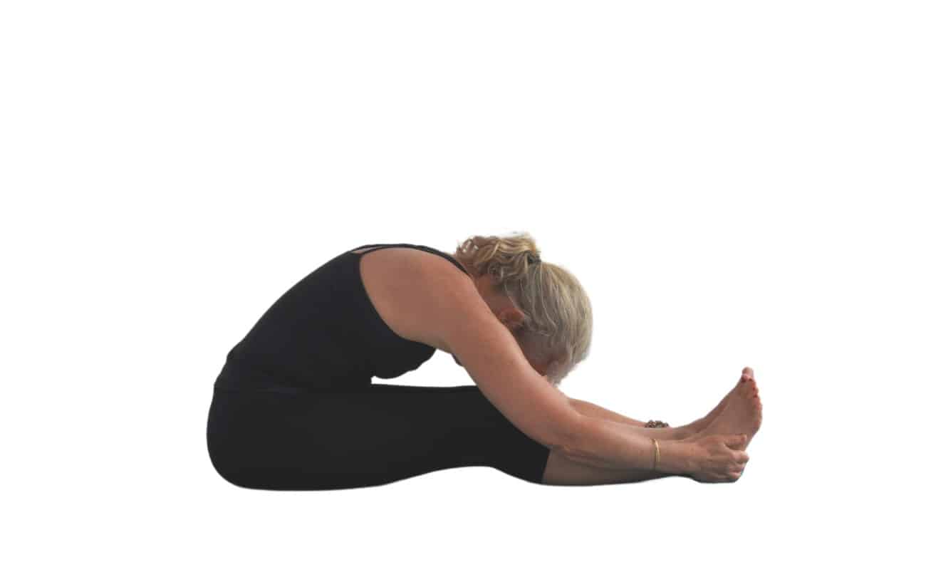 a woman doing a seated forward bend pose