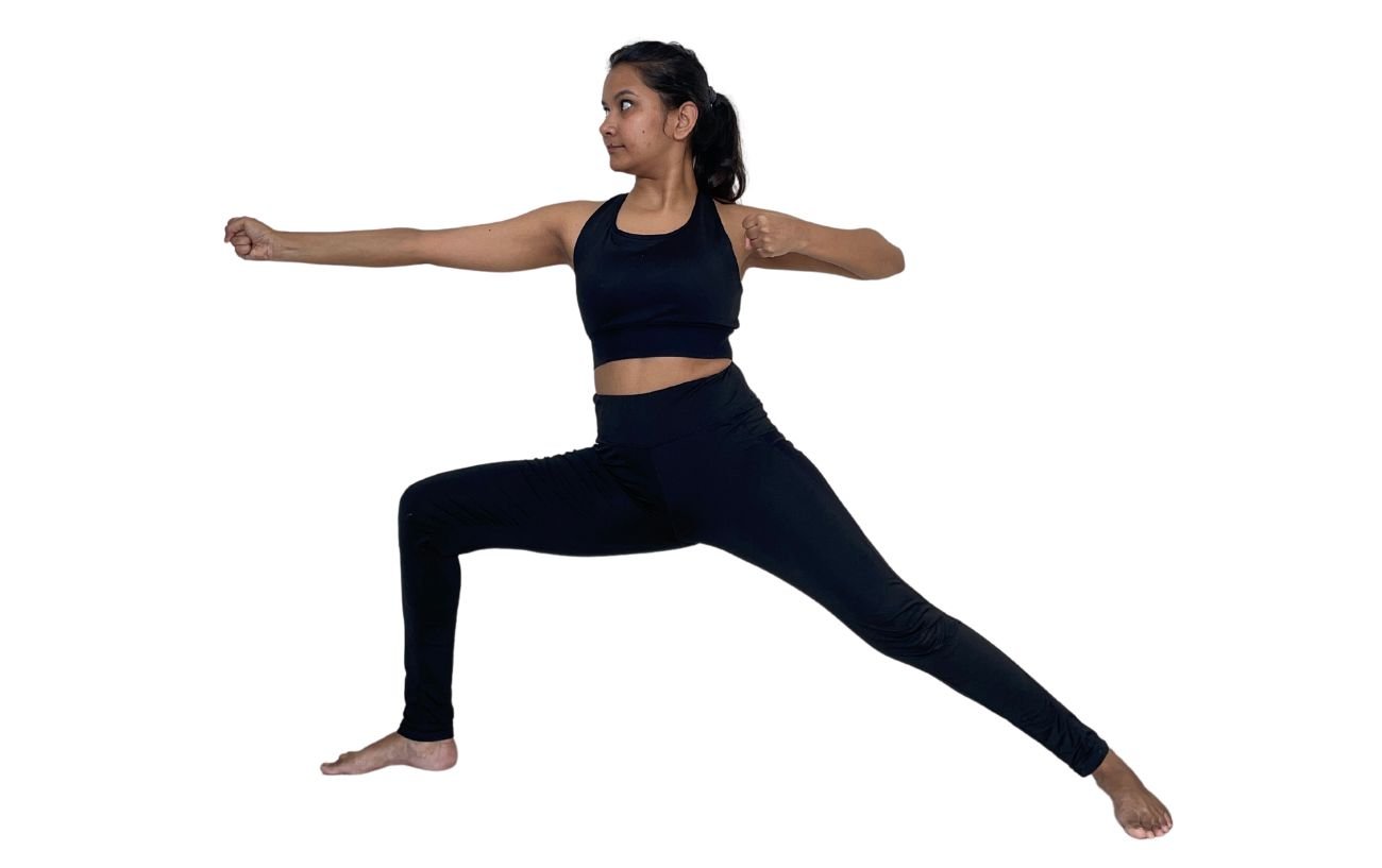 a woman in black yoga clothes doing standing archers pose