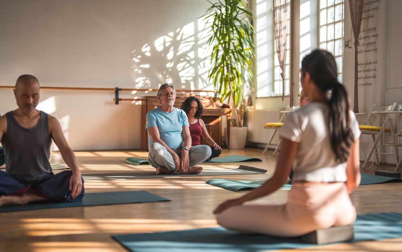 a yoga class sitting in meditation