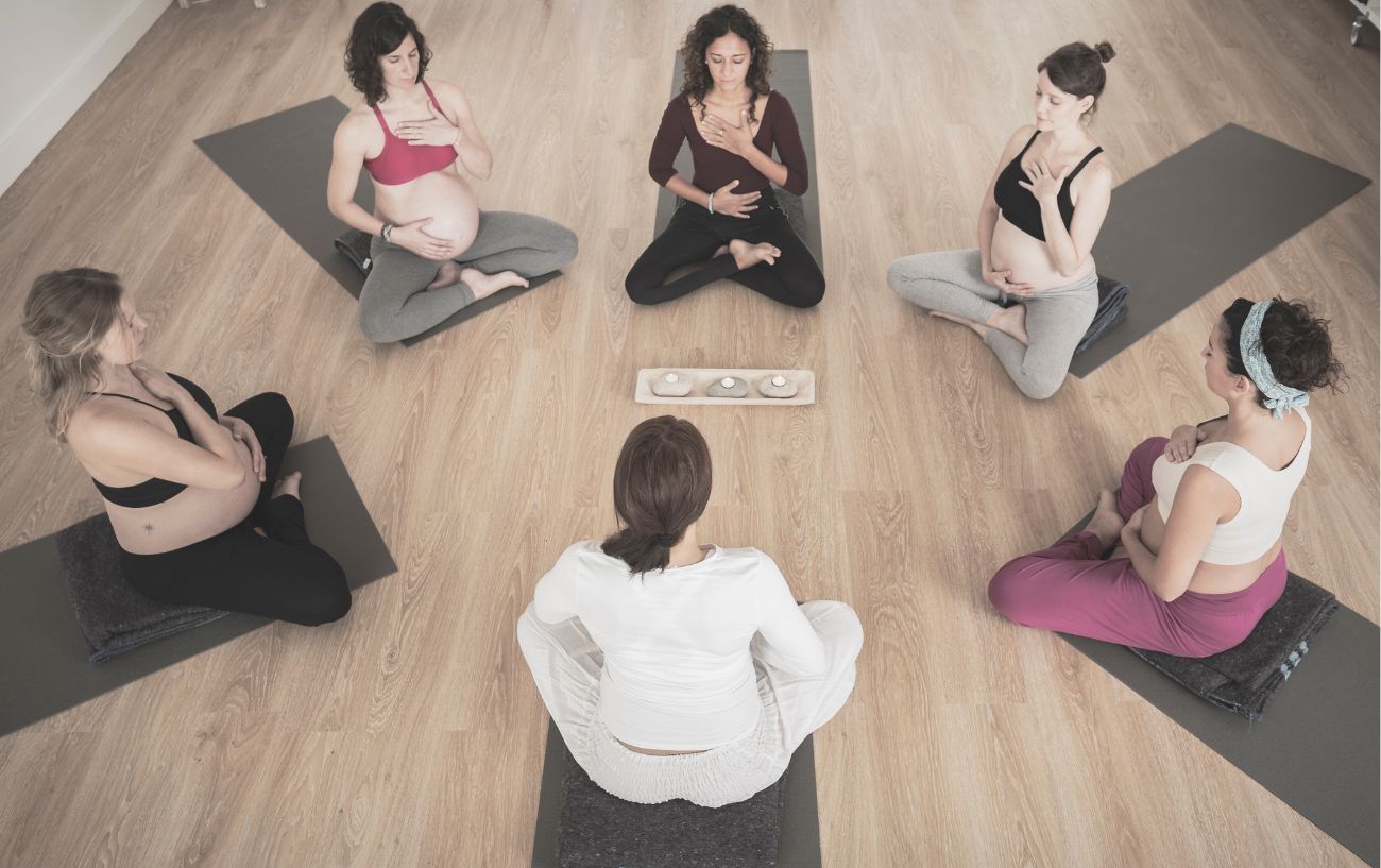 pregnant women practicing yoga in a circle