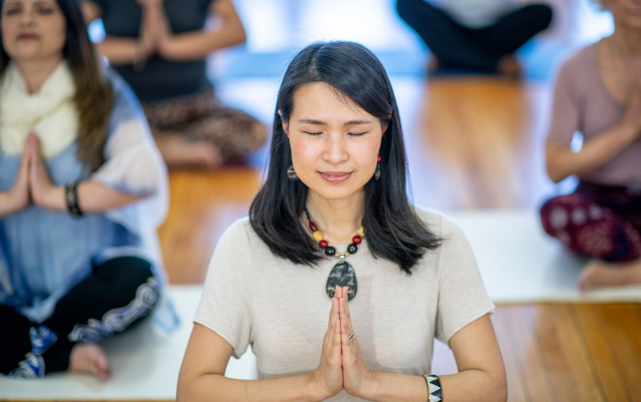 a woman with her hands in prayer