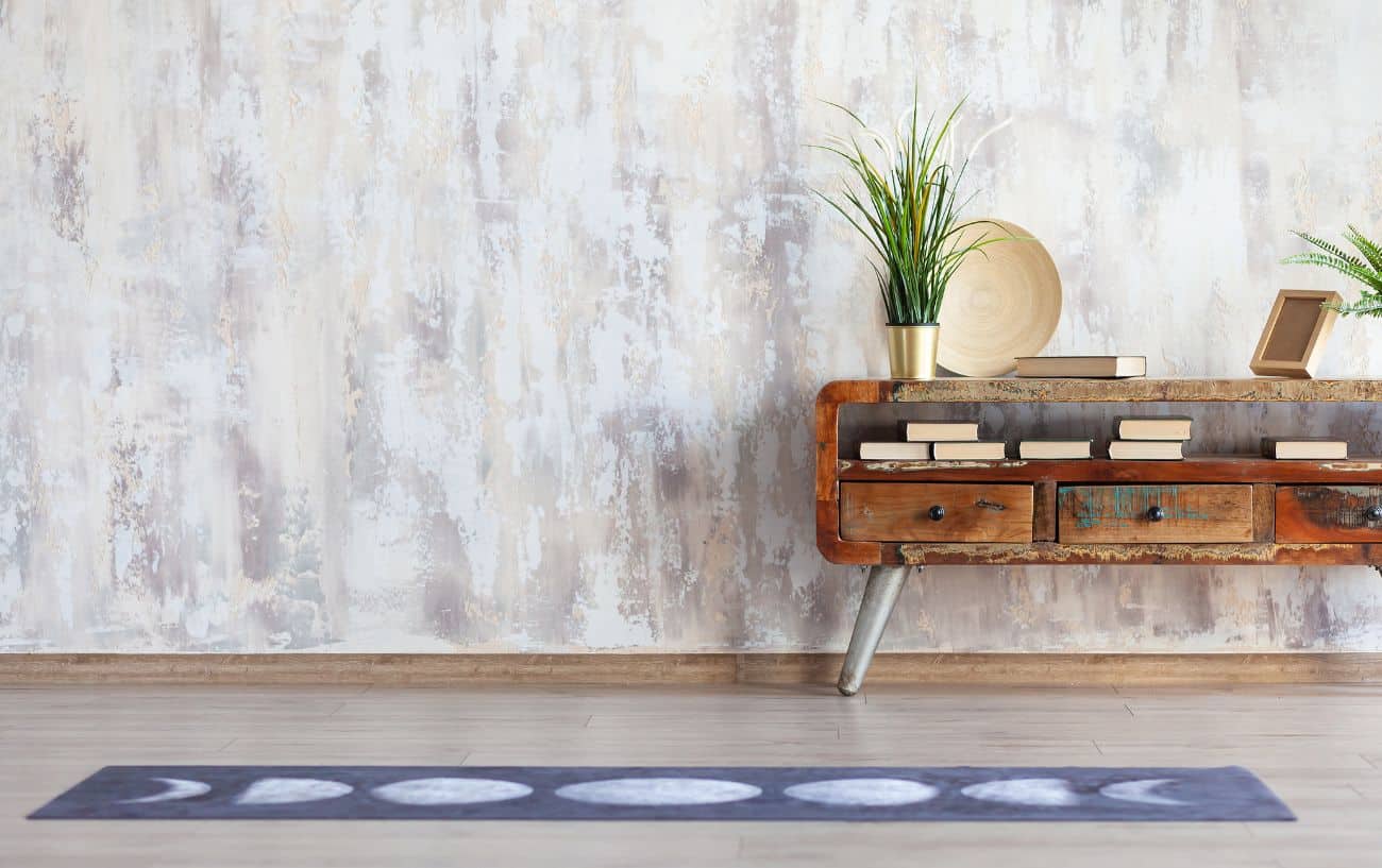 a yoga mat with books on a table behind it