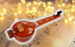 a veena against a background of written music and lights