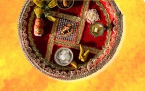 a puja plate in front of an orange background