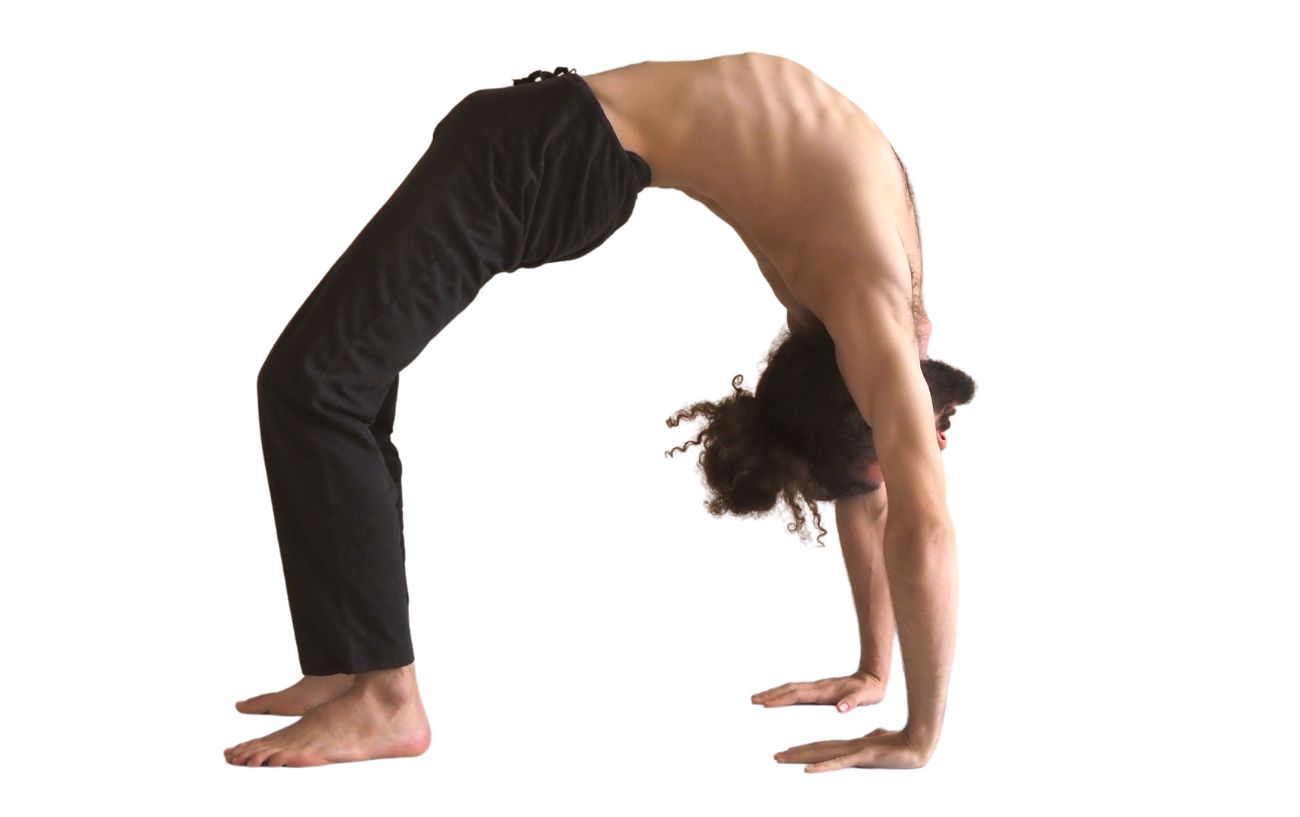 a man wearing black yoga clothes in wheel pose